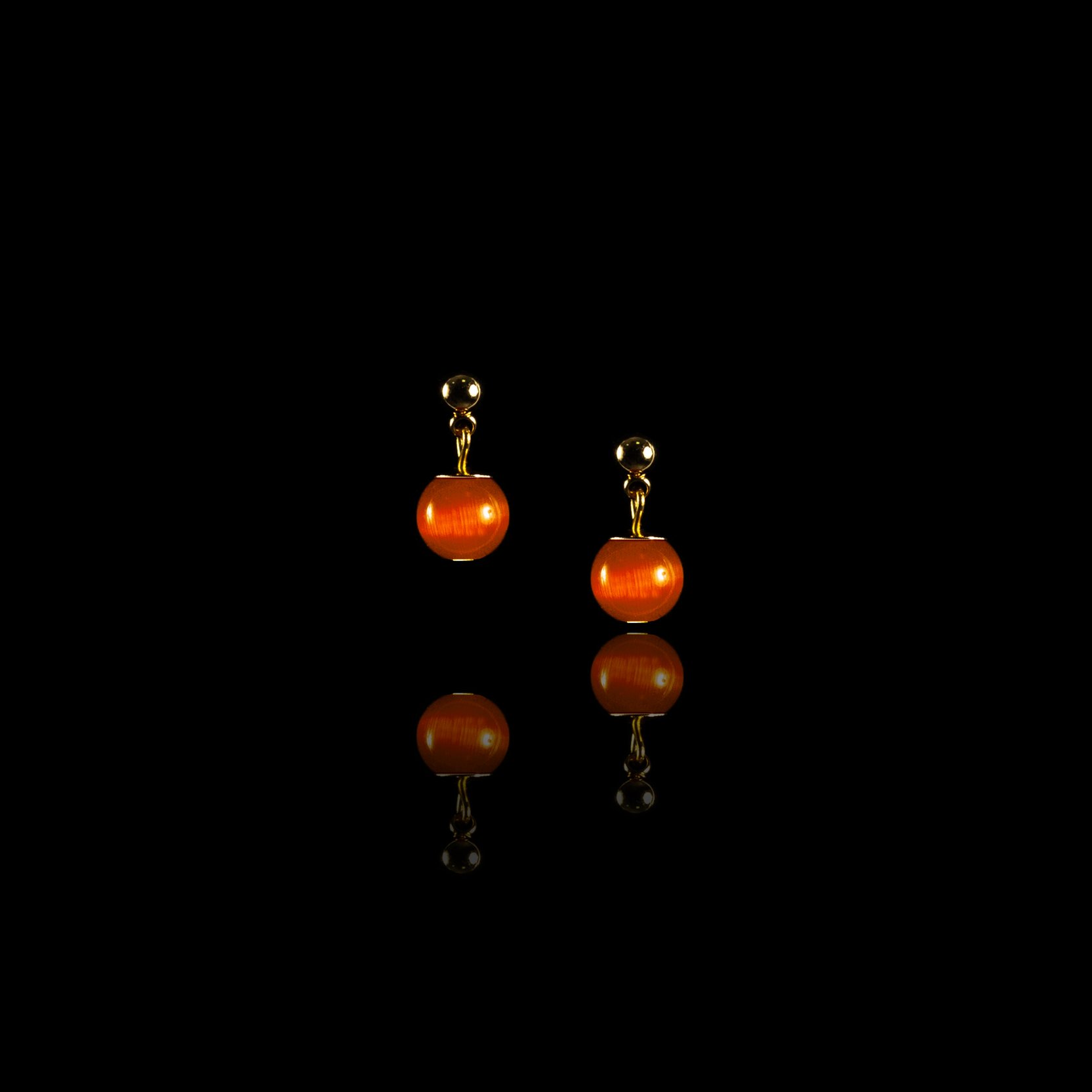 Маленькие серьги-гвоздики с оранжевым камнем.