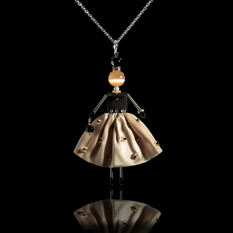Doll-pendant in a light beige silk skirt