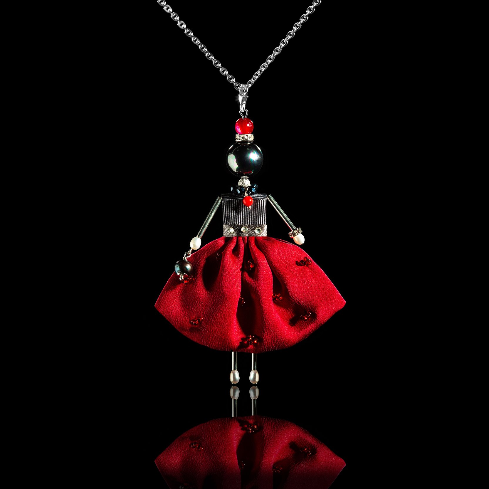 Luxurious pendant doll in a burgundy-colored silk skirt