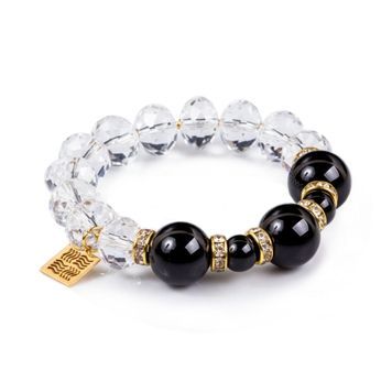 Crystal bracelet with natural black agates and zirconia accents on white background