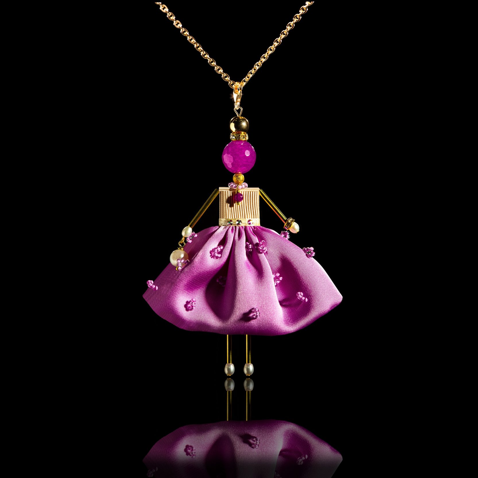 Delicate doll-pendant in a silk lilac skirt