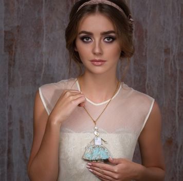 Jewelry Doll Pendant &ldquo;Princess Teresa in the Sky Dress&rdquo; on a model in an elegant evening outfit