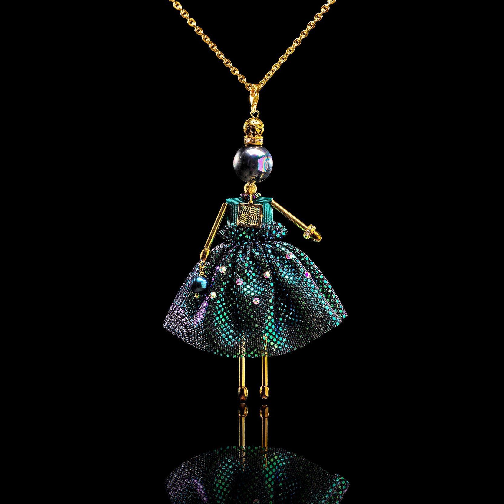 SARANA&reg; Mira Jewelry Doll Pendant on a black background