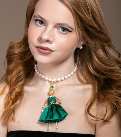 Charming doll-pendant in emerald green color.