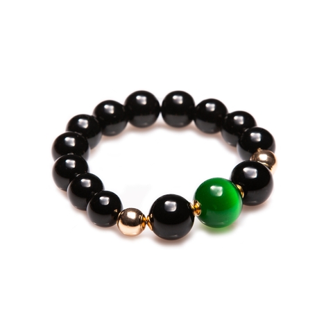 A black agate bracelet with a green stone.