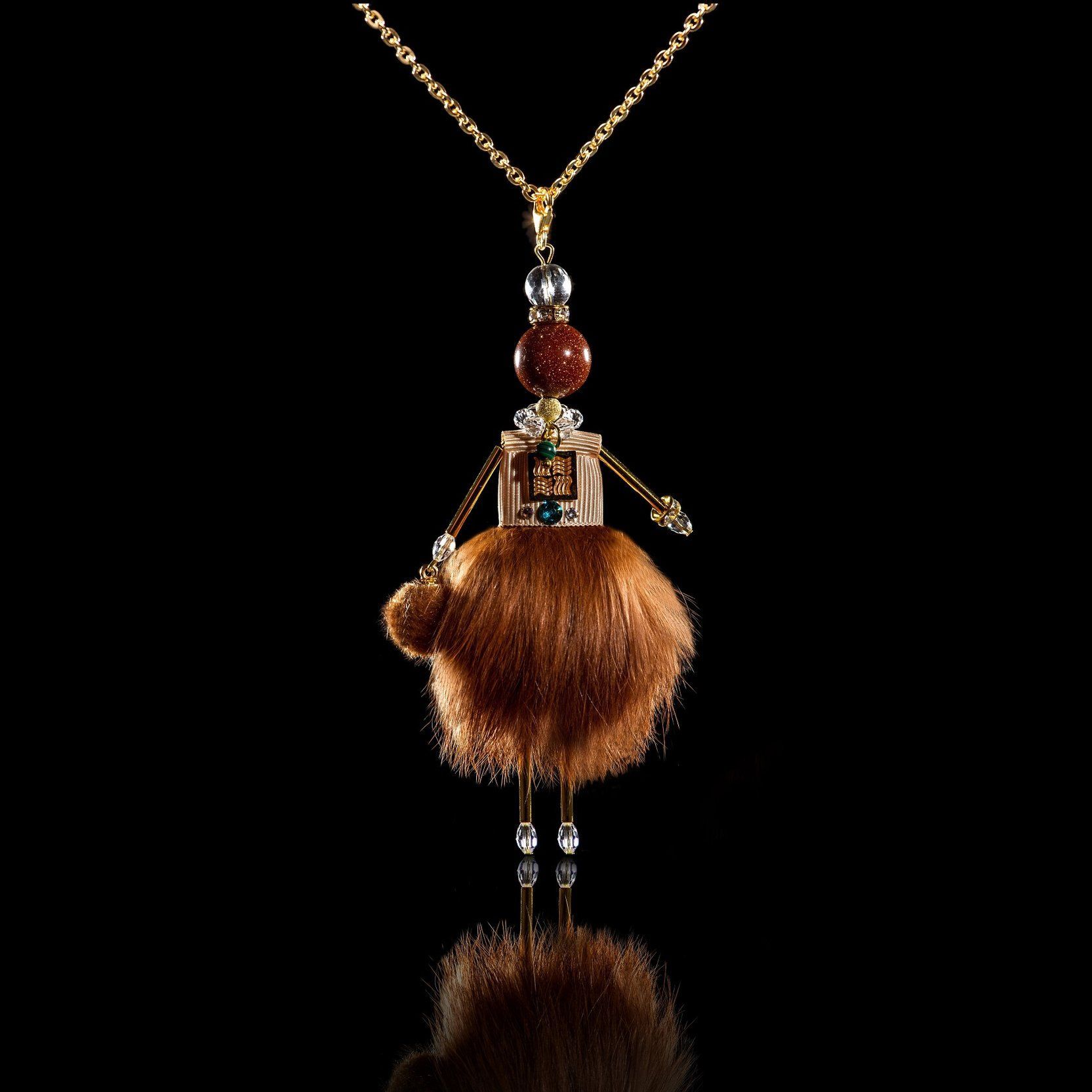 Jewelry doll pendant "Red-haired Beauty" on a black background