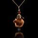 Jewelry doll pendant "Red-haired Beauty" on a black background