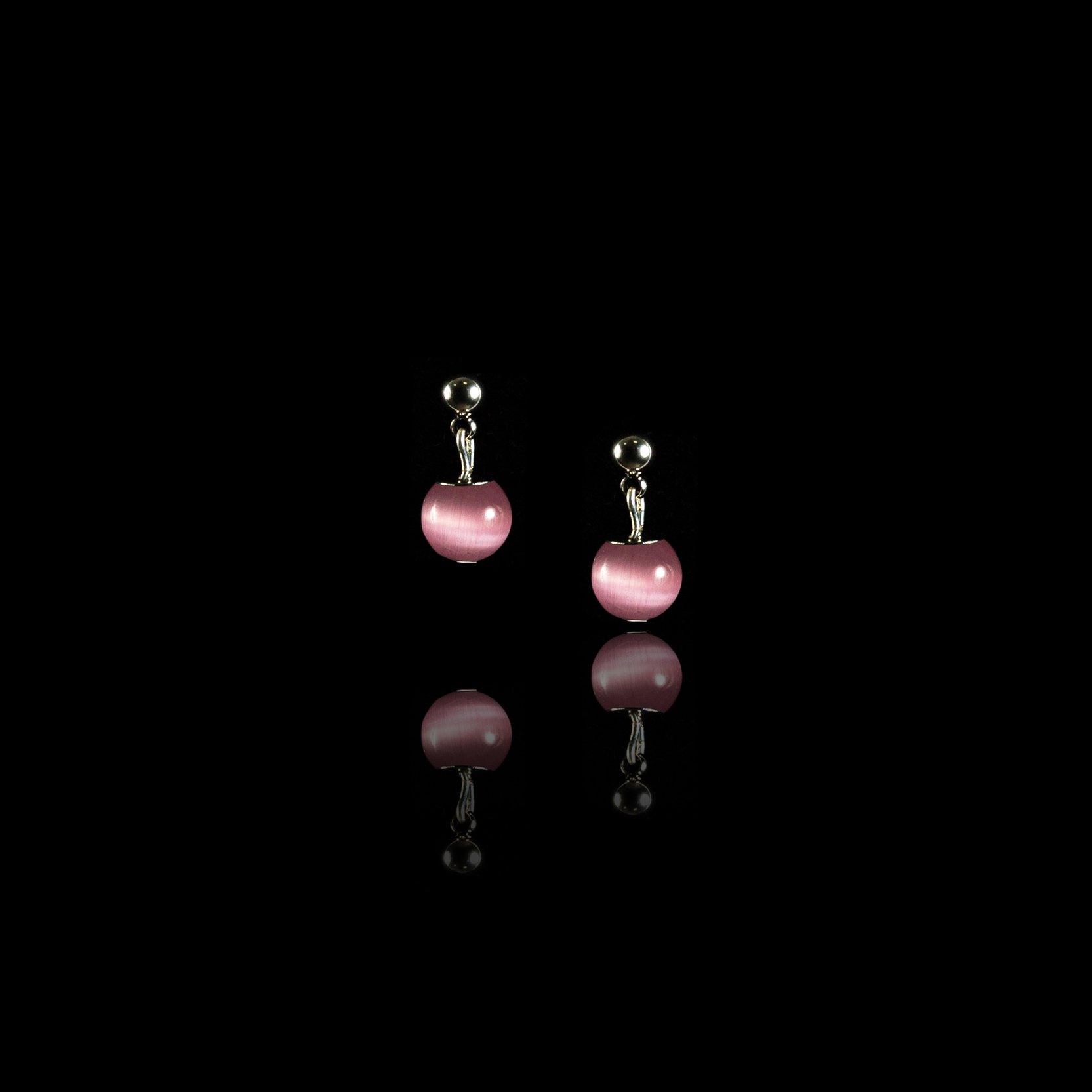 Small stud earrings with a pink stone.
