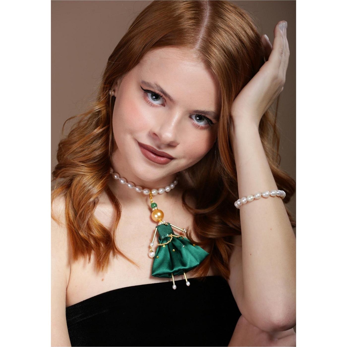 Emerald-green doll pendant with a golden pearl — a striking jewelry trend by SARANA®